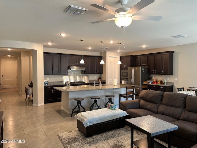 15301 W Moreland St, Goodyear, AZ 85338 - living area featuring light tile patterned floors, visible vents, and a ceiling fan