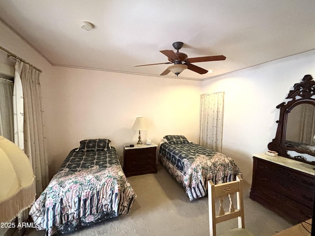 bedroom with ornamental molding, light colored carpet, and ceiling fan