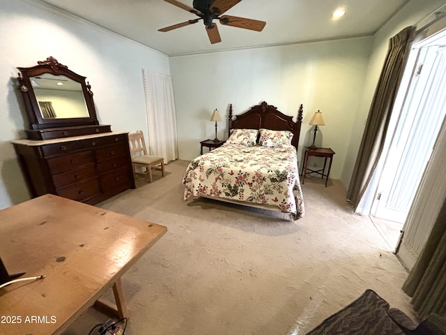 carpeted bedroom featuring ornamental molding and ceiling fan