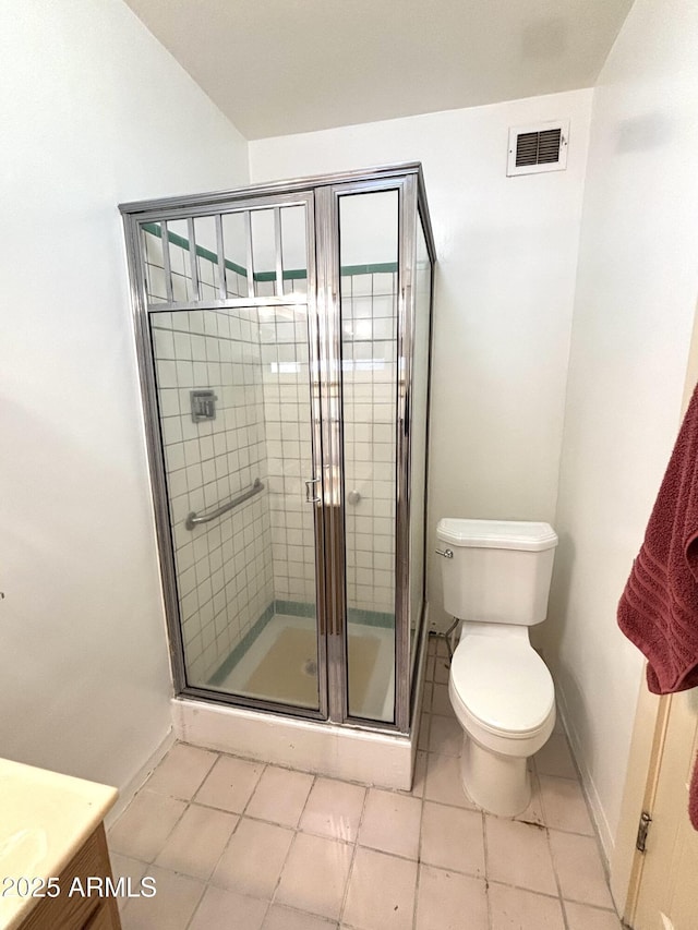 bathroom featuring vanity, tile patterned flooring, a shower with door, and toilet