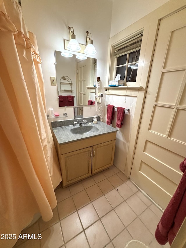 bathroom with tile patterned flooring and vanity