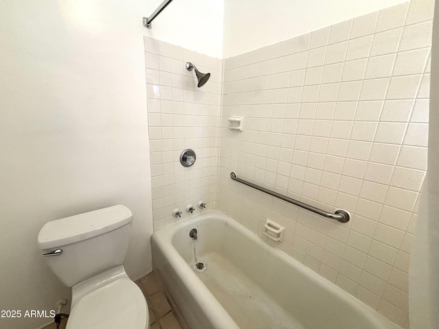 bathroom with tiled shower / bath combo and toilet