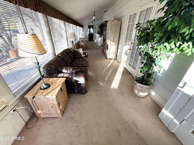 corridor featuring light carpet and vaulted ceiling