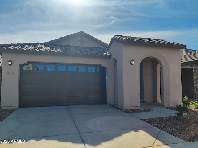 9137 W Sells Dr, Phoenix, AZ 85037 - mediterranean / spanish home with an attached garage, concrete driveway, stucco siding, and a tile roof