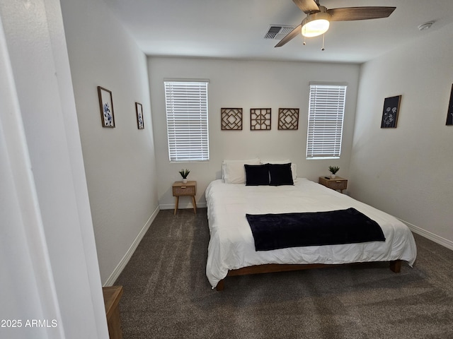 9137 W Sells Dr, Phoenix, AZ 85037 - bedroom with dark colored carpet, ceiling fan, and baseboards