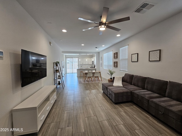9137 W Sells Dr, Phoenix, AZ 85037 - living room featuring a ceiling fan, wood tiled floors, and recessed lighting