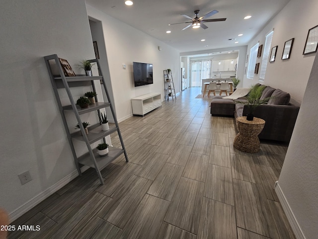 9137 W Sells Dr, Phoenix, AZ 85037 - living room featuring a ceiling fan, recessed lighting, wood finish floors, and baseboards