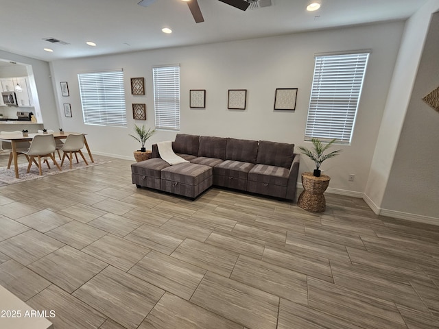 9137 W Sells Dr, Phoenix, AZ 85037 - living room with a ceiling fan, baseboards, and recessed lighting