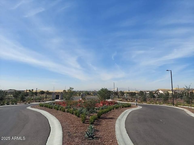 9137 W Sells Dr, Phoenix, AZ 85037 - view of asphalt street featuring street lights and curbs
