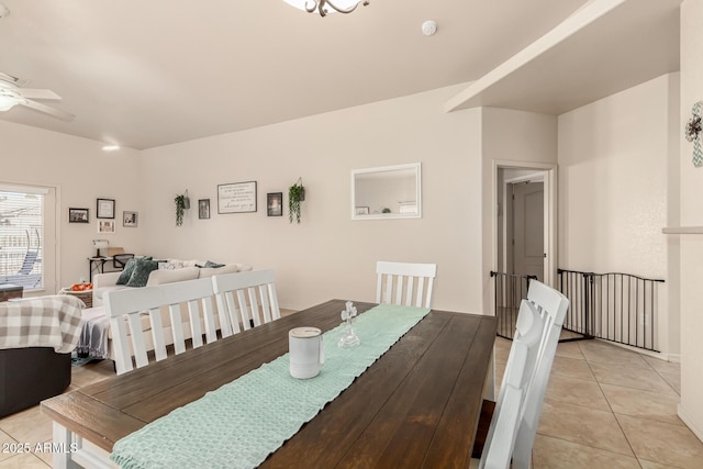 tiled dining area featuring ceiling fan