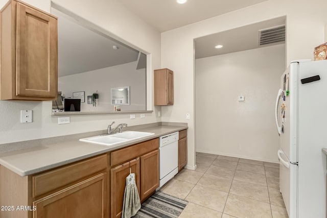 kitchen with light tile patterned flooring, white appliances, and sink