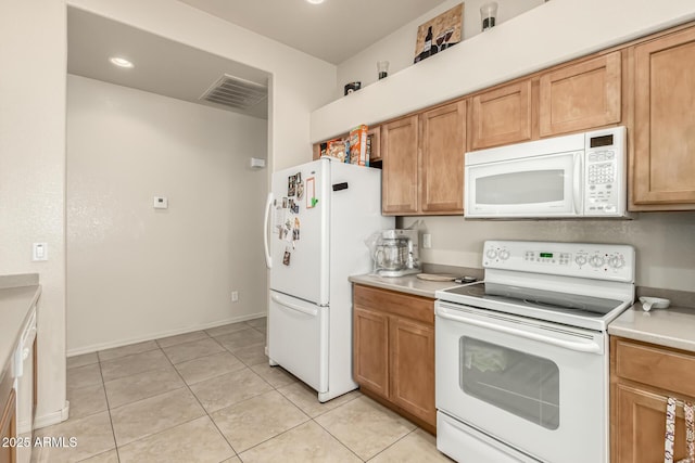 kitchen with light tile patterned floors and white appliances