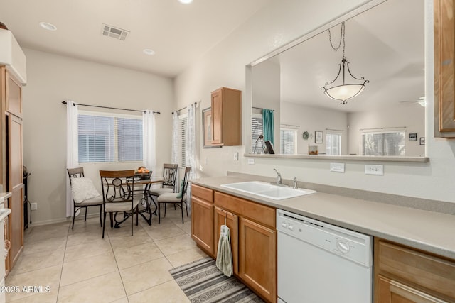 kitchen with dishwasher, sink, ceiling fan, decorative light fixtures, and light tile patterned flooring