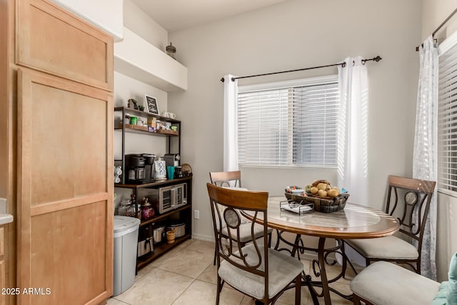 dining room featuring a healthy amount of sunlight and light tile patterned flooring