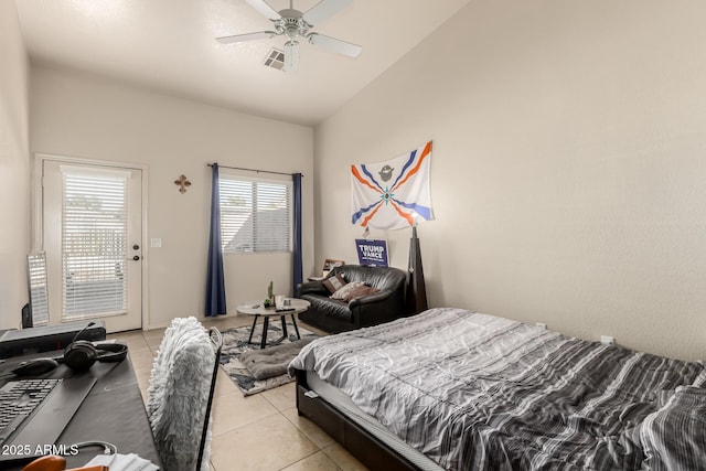 bedroom featuring ceiling fan, light tile patterned floors, and vaulted ceiling