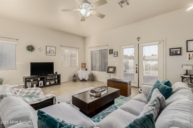 living room with ceiling fan, light tile patterned floors, and french doors