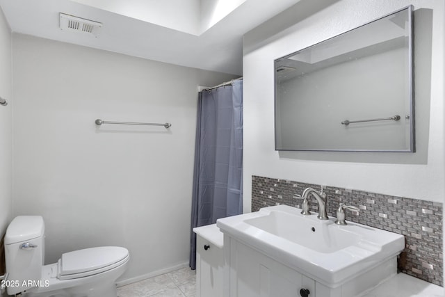 bathroom featuring toilet, tile patterned floors, tasteful backsplash, and sink