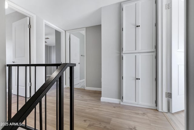 hallway with light hardwood / wood-style flooring