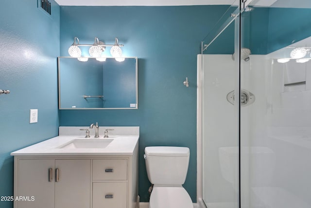 bathroom with walk in shower, vanity, and toilet