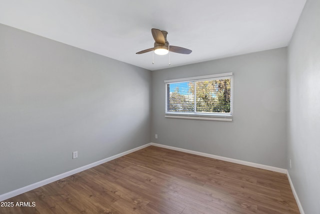 spare room with hardwood / wood-style floors and ceiling fan