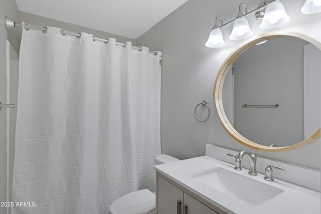 bathroom featuring a shower with shower curtain, vanity, and toilet