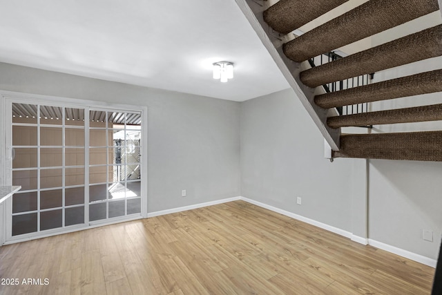 empty room with light hardwood / wood-style flooring