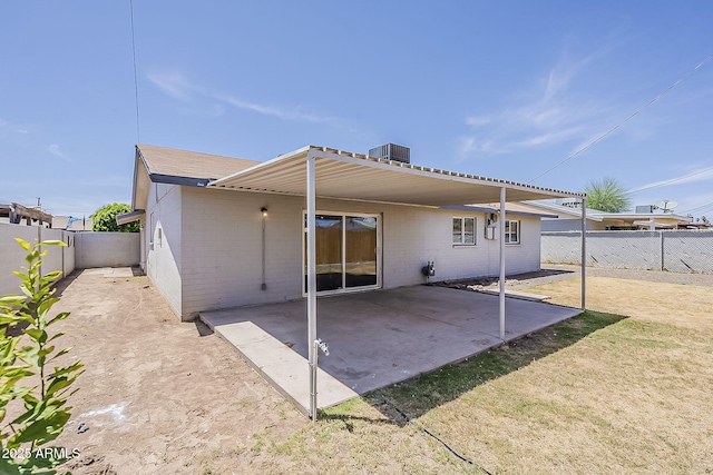 3017 N 46th Dr, Phoenix, AZ 85031 - rear view of house featuring a fenced backyard, a patio, central AC unit, and brick siding