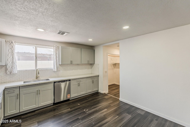 3017 N 46th Dr, Phoenix, AZ 85031 - kitchen featuring stainless steel dishwasher, a sink, gray cabinets, dark wood-style floors, and tasteful backsplash