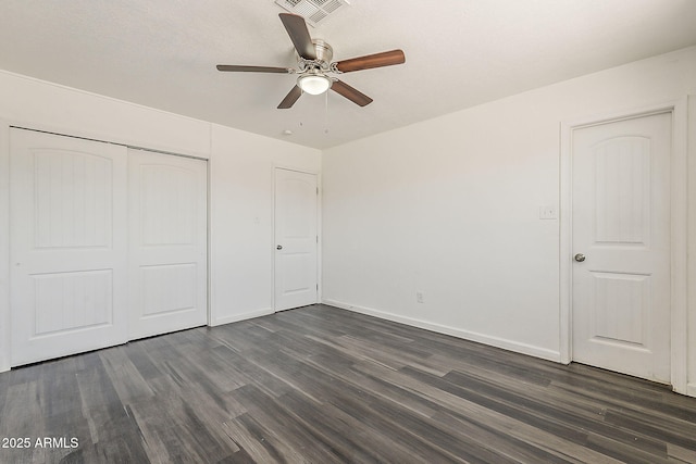 3017 N 46th Dr, Phoenix, AZ 85031 - unfurnished bedroom featuring dark wood finished floors, a closet, baseboards, and a ceiling fan