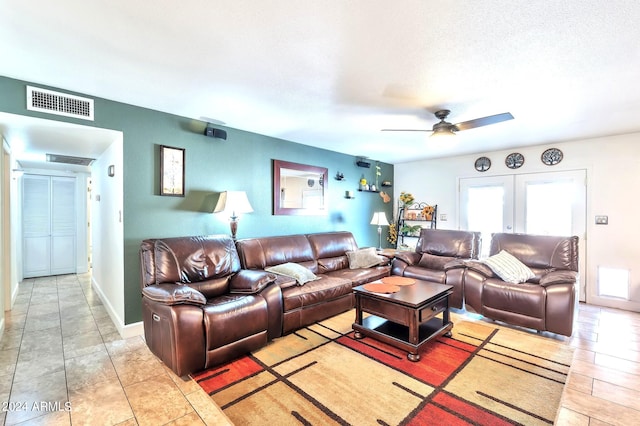 living room featuring french doors, a textured ceiling, and ceiling fan