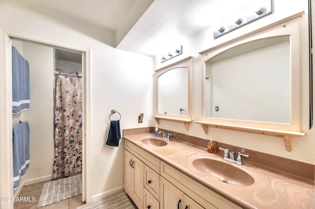 bathroom with vanity, a textured ceiling, tile patterned floors, and walk in shower