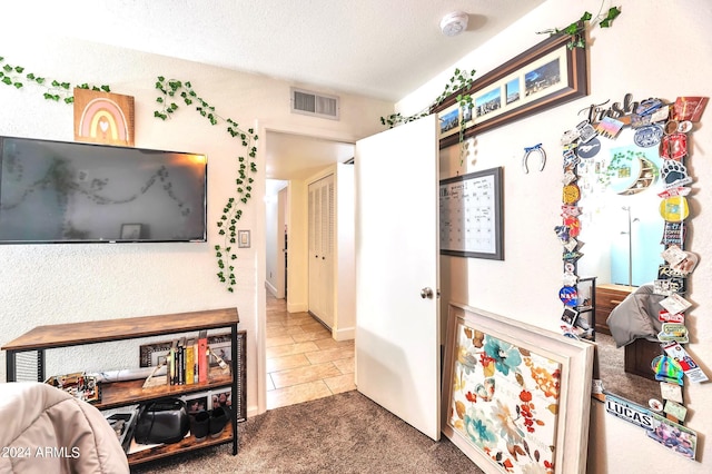 carpeted bedroom featuring a textured ceiling