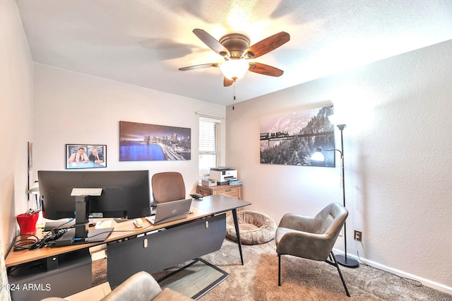 carpeted office space featuring a textured ceiling and ceiling fan