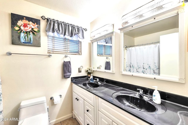 bathroom featuring vanity, curtained shower, a textured ceiling, and toilet