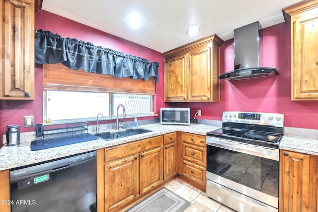 kitchen featuring light stone counters, light tile patterned floors, sink, wall chimney exhaust hood, and stainless steel appliances