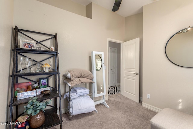 living area featuring carpet floors and baseboards