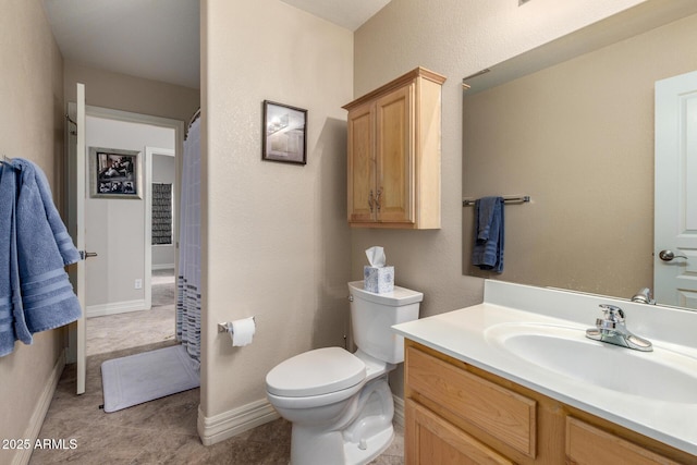 bathroom with toilet, tile patterned flooring, baseboards, and vanity