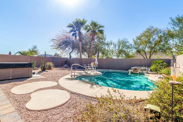 view of pool featuring a hot tub, a patio area, a fenced backyard, and a fenced in pool