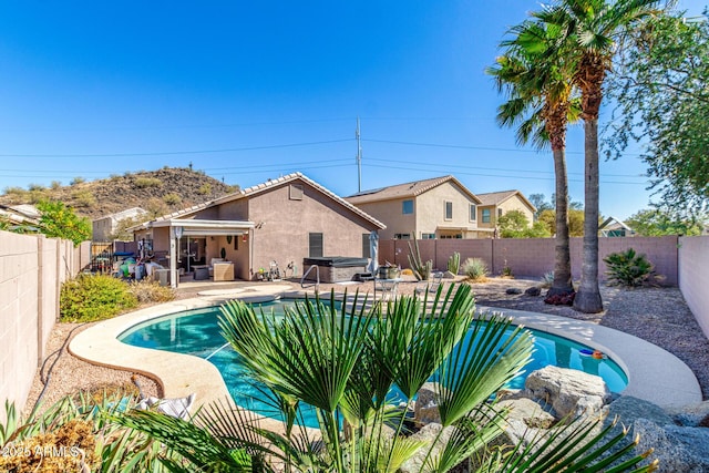 view of swimming pool with a fenced in pool, a fenced backyard, and a patio