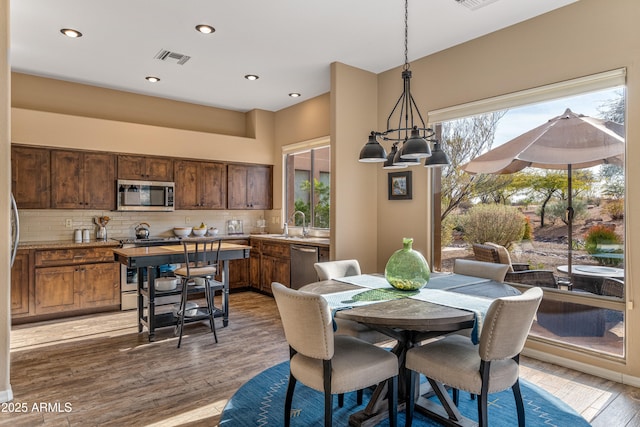 dining room with hardwood / wood-style flooring and sink