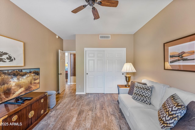 living room featuring ceiling fan and light wood-type flooring