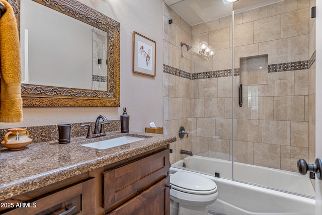 full bathroom featuring vanity, enclosed tub / shower combo, and toilet