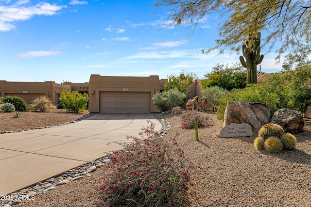 pueblo-style home featuring a garage