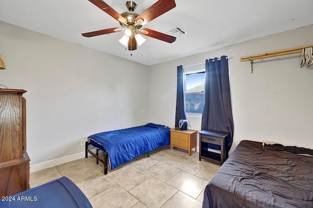 tiled bedroom featuring ceiling fan