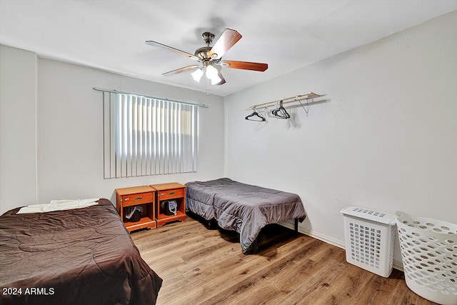 bedroom with wood-type flooring and ceiling fan