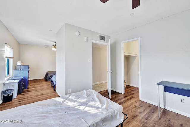 bedroom with wood-type flooring and ceiling fan