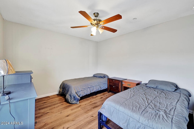 bedroom with hardwood / wood-style floors and ceiling fan