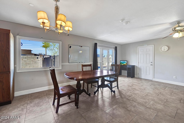 dining area featuring a chandelier, tile flooring, and french doors