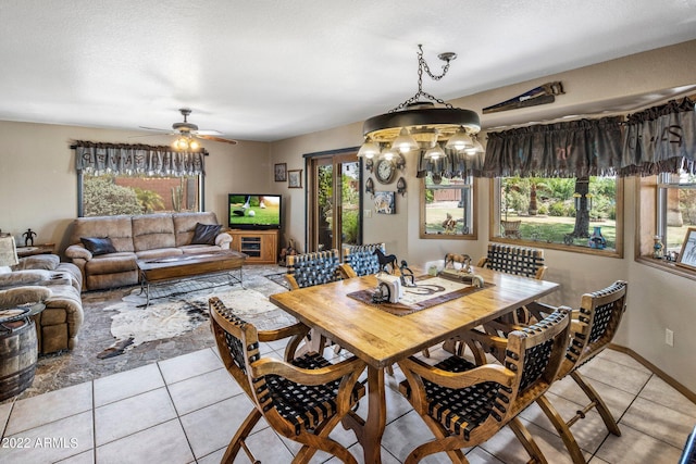 dining room featuring light tile patterned flooring, a textured ceiling, and ceiling fan