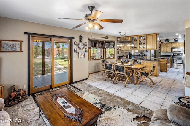 living room featuring light tile patterned floors and ceiling fan